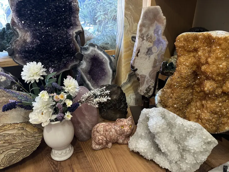 Golden citrine geode with white flowers and amethyst at Stone Room