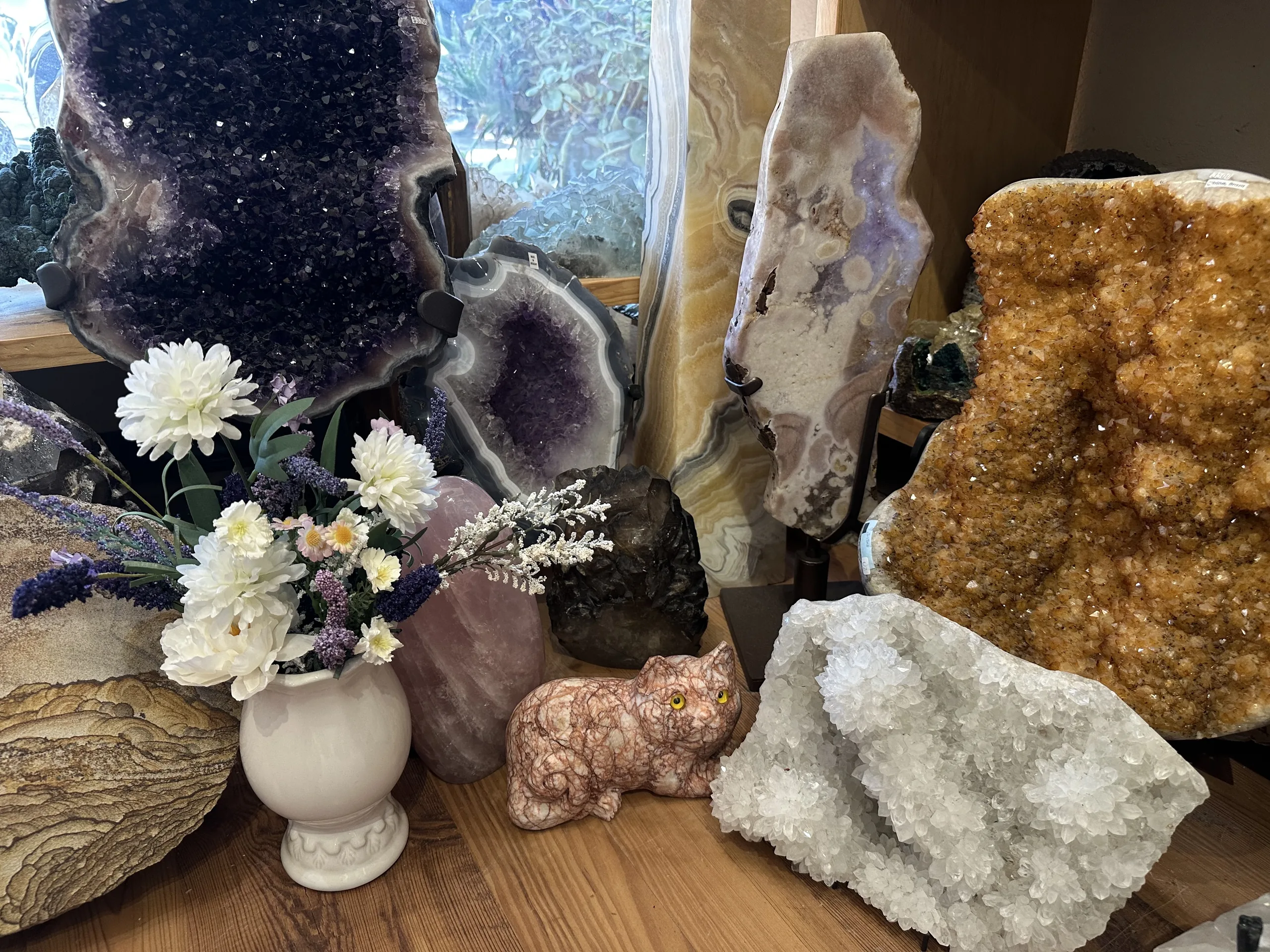 Golden citrine geode with white flowers and amethyst at Stone Room